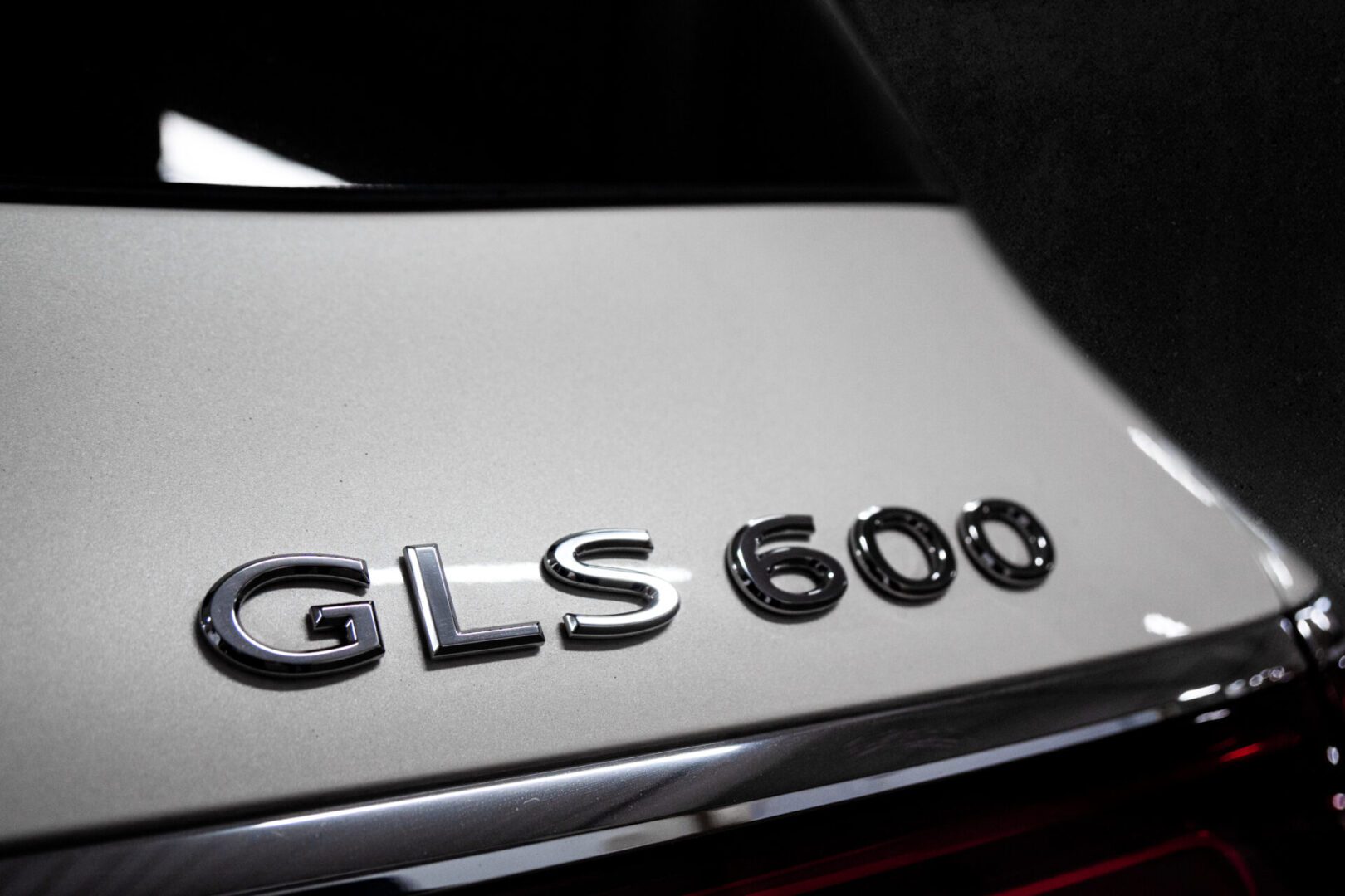 A close up of the letters on the hood of a car