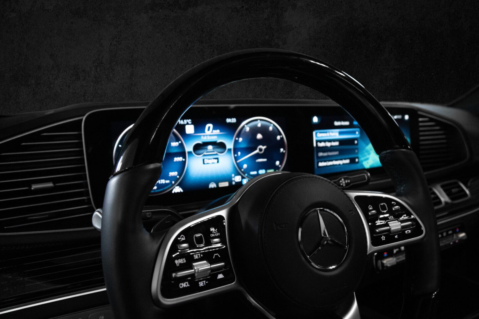 A car dashboard with the steering wheel turned to the left.