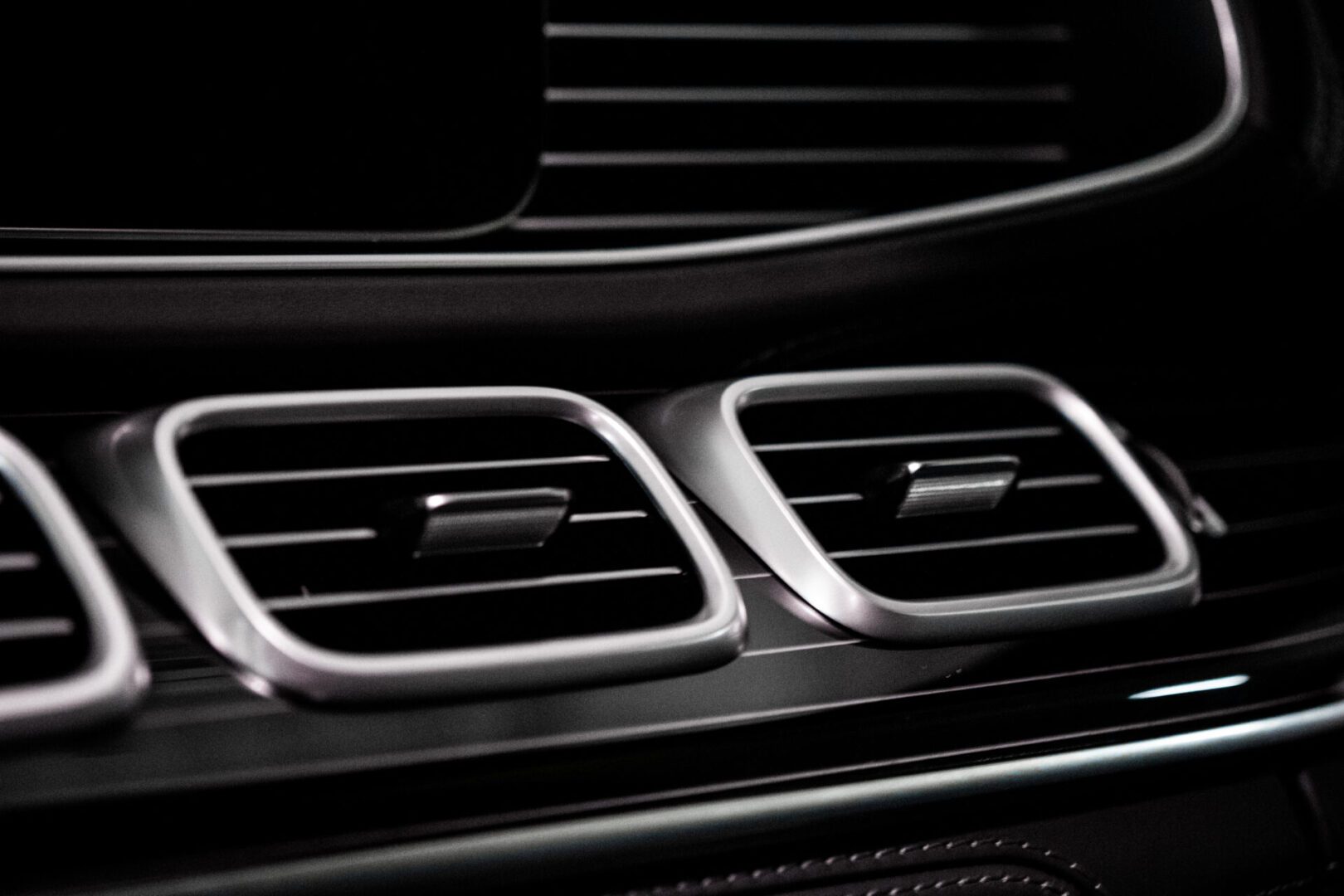 A close up of the air vents in an automobile.
