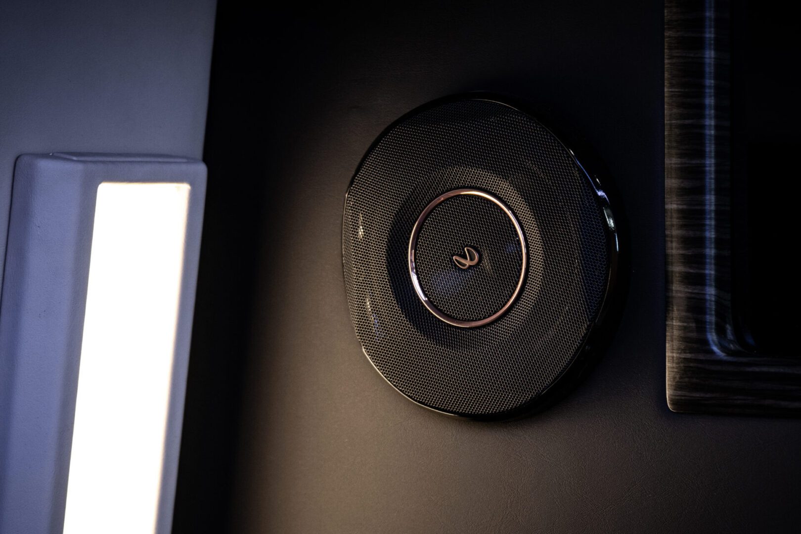 A black wall clock mounted to the side of a room.